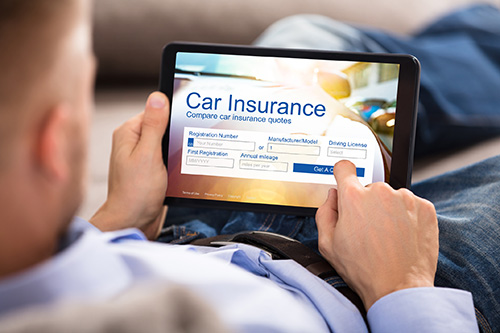 Person looking at car insurance on a tablet computer